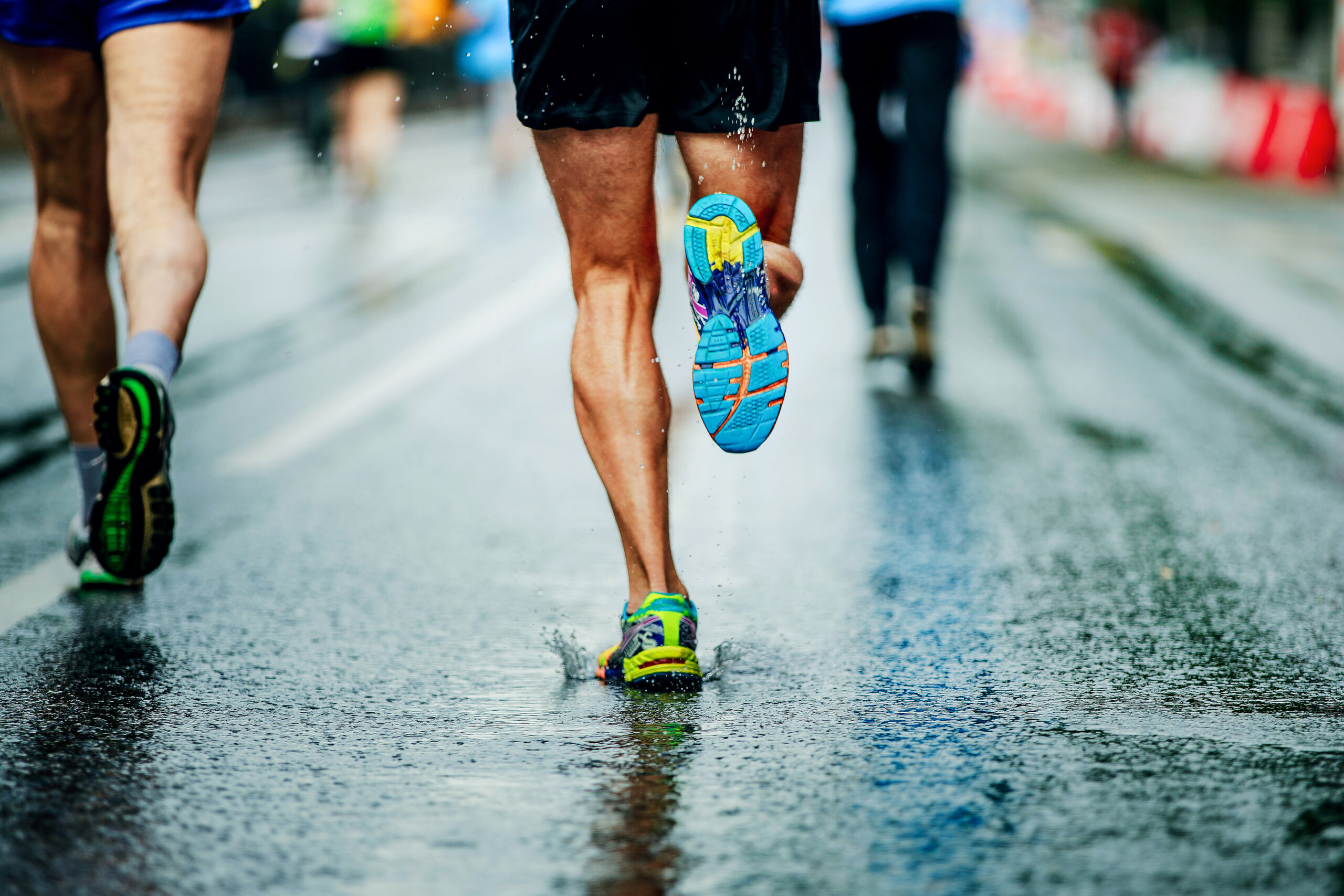 water sprays from under running shoes